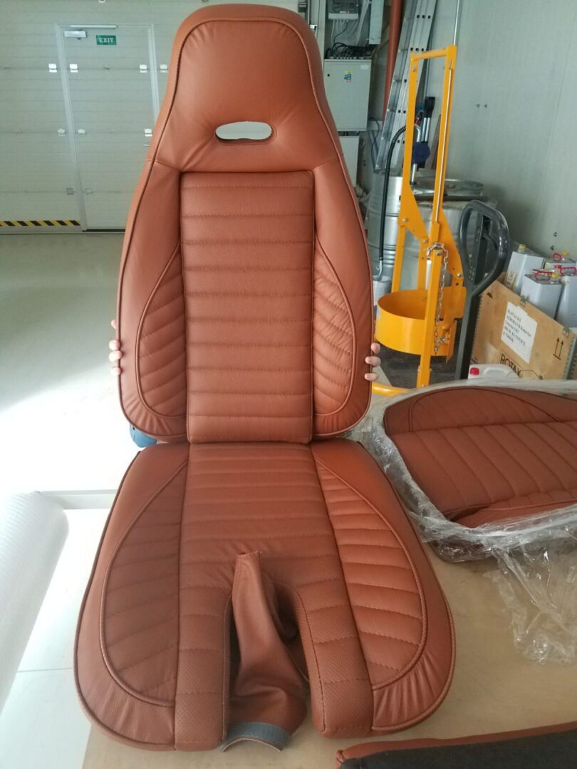 A car seat that is brown and has been painted.