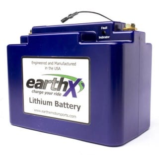 A blue lithium battery is sitting on top of a table.