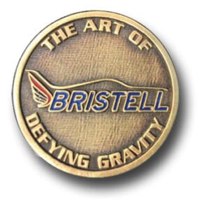 A gold colored coin with the words " bristell " on it.