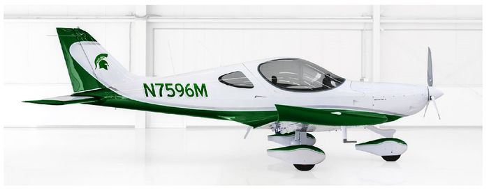 A small white and green plane sitting in the middle of a room.