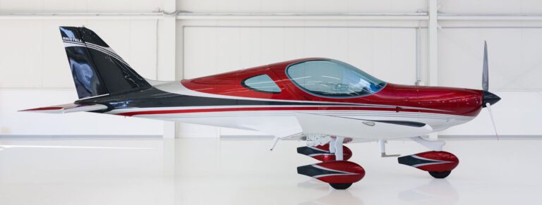 A red and white plane sitting on top of a table.
