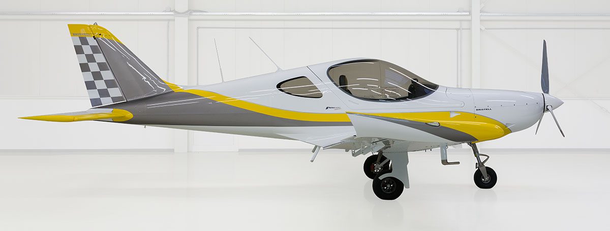 A small airplane with yellow and grey trim.
