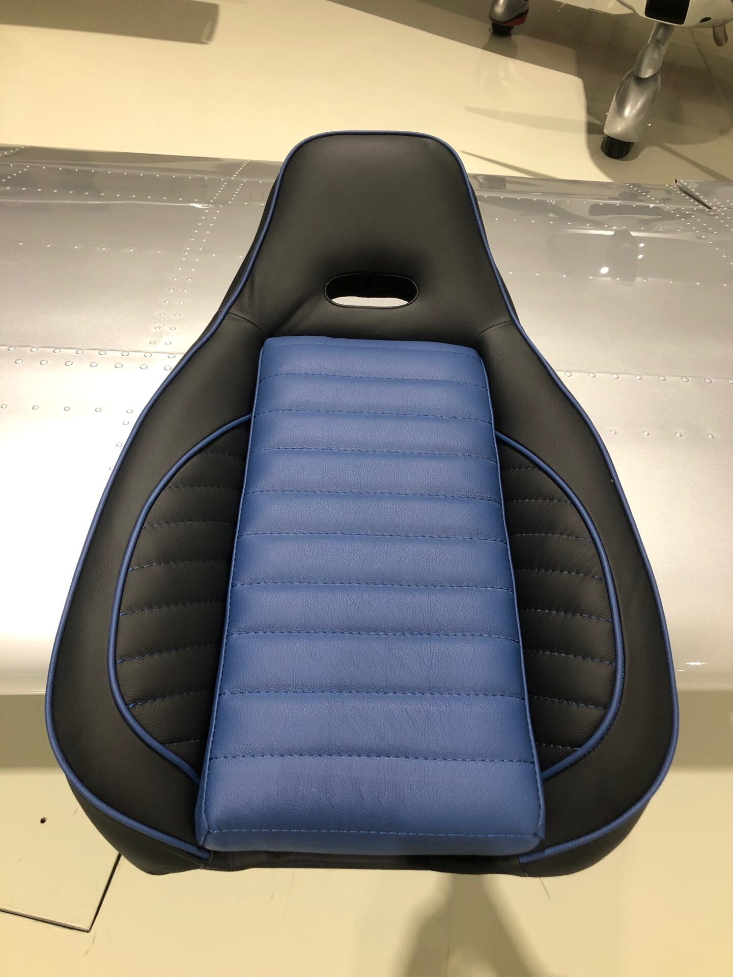A seat with blue and black leather on it
